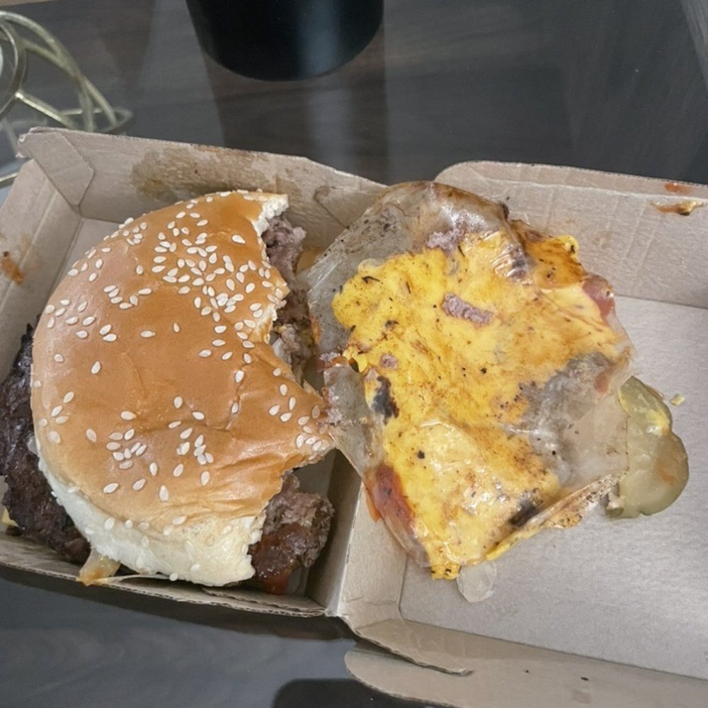 McDonald's - The plastic patty partition is still on the burger. Someone just said "well, fuck it". - Burgers Near Me - San Diego, California