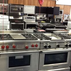 Bray & Scarff - Kitchen showroom with stainless steel wolf ranges in display and more ranges in the back