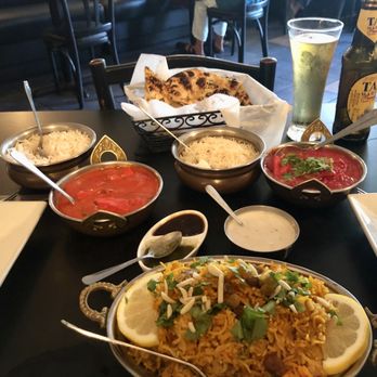 Shiva Indian Restaurant - Chicken biriyani in foreground, butter chicken red dish on left and chicken tikka in red dish on right. - Indian Near Me - Mount Dora, Florida Shiva Indian Restaurant - Chicken biriyani in foreground, butter chicken red dish on left and chicken tikka in red dish on right. - Indian Near Me - Mount Dora, Florida