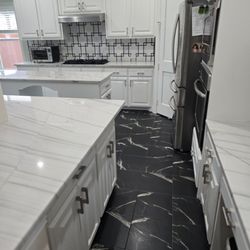 Jay the Builder - Kitchen remodel and design with quartzite countertops, marble backsplash, black marble look porcelain tiles.