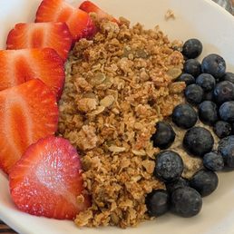 Vanilla bean oats with berries, coconut on the side