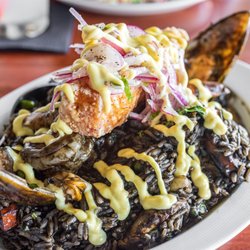Pisco Bar - Paella Pisco Bar ($32) paella w/ calamari ink sauce w/ mixed seafood, chicken, sausage, & ají amarillo aioli topped w/ crispy fish