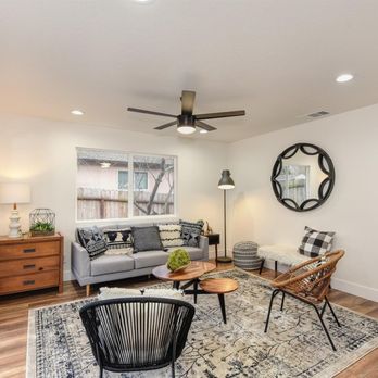 Elevate Renovations - a living room with a ceiling fan - General Contractors Near Me