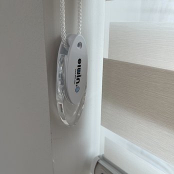 A Blinds - Non motorized opener.  We opted not to have them attached but they can be attached to the wall with safety features for kids - Shutters Near Me - Buena Park, California