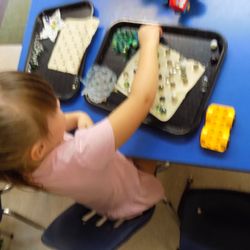 O'fallon Early Childhood Center - Using marbles on a part of a bath mat to strengthen fine motor muscles.