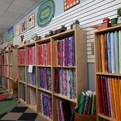 Sew ‘N Sweep - Fabric Wall - Free Spirit Fabrics and several other prints.
