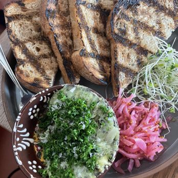 Finca - Grilled sourdough with herb butter and pickled onions - Wine Bars Near Me - San Diego, California Finca - Grilled sourdough with herb butter and pickled onions - Wine Bars Near Me - San Diego, California