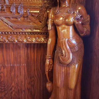 Phnom Penh - a wooden statue of a woman - Thai Near Me - Cleveland, Ohio