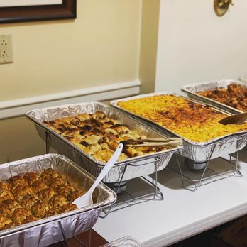 Steez Catering - trays of food on a table - Caterers Near Me