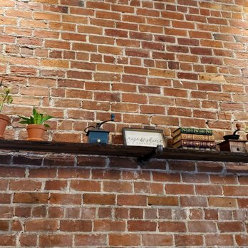 Mill Town Roasters - a brick wall with potted plants - Coffee Roasteries Near Me - Fredericton, New Brunswick