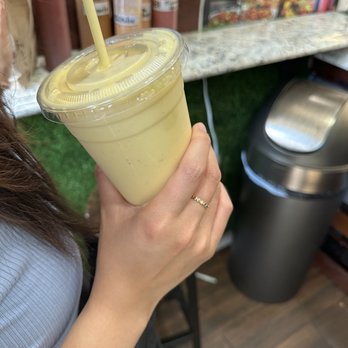 Fresh Stop - a woman holding a drink in her hand - Dominican Near Me - New York, New York