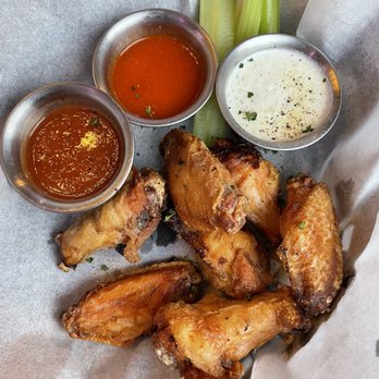 The Rusty Melon - a basket of chicken wings and dipping sauces - Bars Near Me - Erie, Colorado