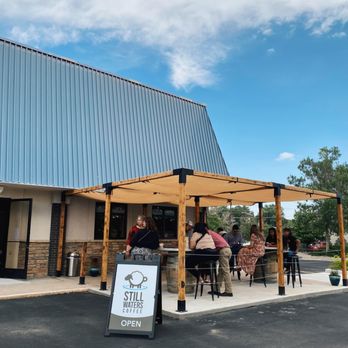 Still Waters Coffee - people sitting at tables under a canopy - Coffee & Tea Near Me - Greeley, Colorado Still Waters Coffee - people sitting at tables under a canopy - Coffee & Tea Near Me - Greeley, Colorado