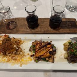 Flight of three entrees and three paired wines. Flight of three entrees and three paired wines.