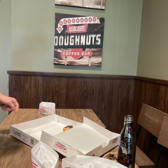 Krispy Kreme - a man cutting a doughnut - Donuts Near Me - Deerfield Beach, Florida Krispy Kreme - a man cutting a doughnut - Donuts Near Me - Deerfield Beach, Florida