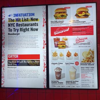 Moonburger - Menu - Two digital menu boards at Moonburger in Brooklyn, NY, display various food items including burgers, fries, shakes, and beverages. The left board features a headline about NYC restaurants and a section titled 'EATER' with a focus on burger offerings. The right board showcases images of cheeseburgers, a full moon combo meal, classic fries, hot fries, cheese sauce, and milkshake options, with prices and descriptions. The background is red tiled, and the boards are illuminated. - Burgers Near Me - Brooklyn, New York