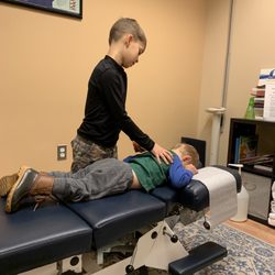 Lighthouse Chiropractic - My 8 year old "practicing" to be a chiropractor on his little 2 year old brother :)