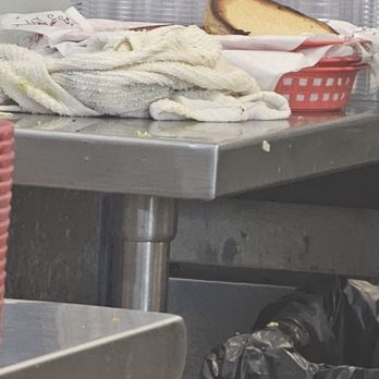 Longhorn Cafe - Dirty rag setting next to prepped baskets with paper. The guy was putting hamburger buns in basket. - Burgers Near Me - San Antonio, Texas Longhorn Cafe - Dirty rag setting next to prepped baskets with paper. The guy was putting hamburger buns in basket. - Burgers Near Me - San Antonio, Texas