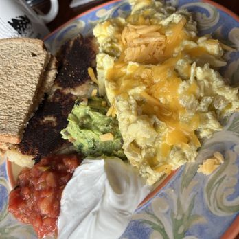 Wild Mountain Cafe - This is the best island scrambled eggs with green chilie, guacamole toast, and signature garlic hash potatoes - American Near Me - Seattle, Washington