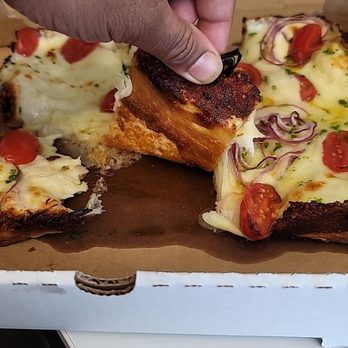 Johnny Pomodoro - a hand grabbing a slice of pizza - Pizza Near Me - Boston, Massachusetts Johnny Pomodoro - a hand grabbing a slice of pizza - Pizza Near Me - Boston, Massachusetts