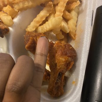 Tasty Wings - a person's finger on a plate of food - Chicken Wings Near Me - Birmingham, Alabama Tasty Wings - a person's finger on a plate of food - Chicken Wings Near Me - Birmingham, Alabama