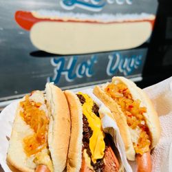 Lou's Hot Dogs - "Regular" order.. Hot onions, sauerkraut, mustard with a dog on left & right with the hot sausage, hot onion, chili, & cheese in the center