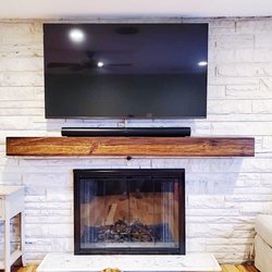 Ocean State Smart Home - 65" LG mounted over a brick fireplace, cords concealed, Sonos Arc soundbar and new mantle installation