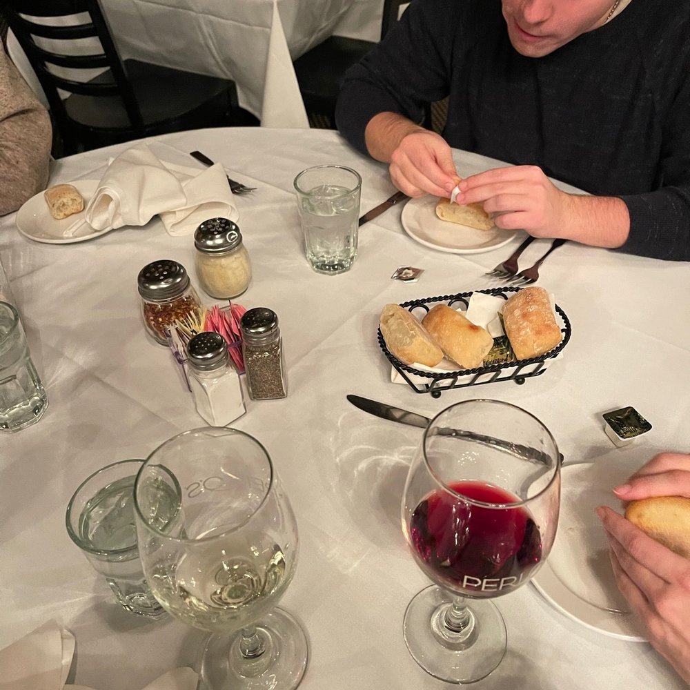 Perlo's - a man and a woman eating at a restaurant - Italian Near Me - East Rochester, New York Perlo's - a man and a woman eating at a restaurant - Italian Near Me - East Rochester, New York
