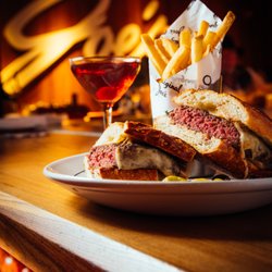 Original Joe's - Joe's Famous Hamburger Sandwich accompanied by French Fries and a Manhattan