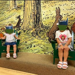 Hundred Acer Woods backdrop and small stage for Story Time.