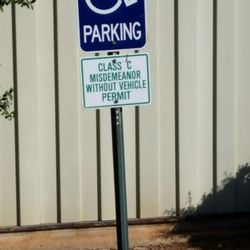 Benchmark Property Management Co - Very little parking, one handicap spot, the lot is in ill repair.