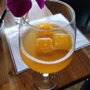 BODHI - 214 Francoise and E'tienne cocktail.  Eat the orchid and the tangerine ice cubes! - Thai Near Me - Indianapolis, Indiana