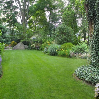 Lawn Dawg - a lush green lawn with a rock in the background - Lawn Services Near Me - Portland, Maine Lawn Dawg - a lush green lawn with a rock in the background - Lawn Services Near Me - Portland, Maine