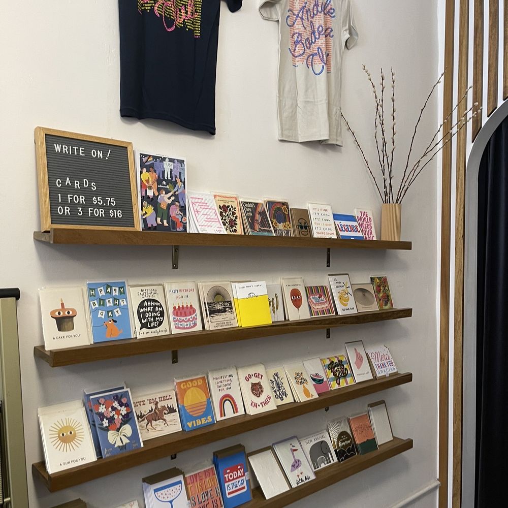 Ándale Market - a display of books and t - shirts - Grocery Near Me - Chicago, Illinois