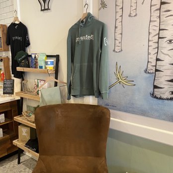 Grounded Coffee Bar - a brown chair and a wall with birch trees - Coffee & Tea Near Me - Frankfort, Illinois