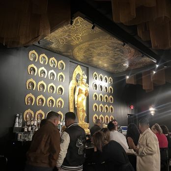 Taipo - a group of people standing in front of a buddha statue - Asian Fusion Near Me - Arlington, Texas Taipo - a group of people standing in front of a buddha statue - Asian Fusion Near Me - Arlington, Texas