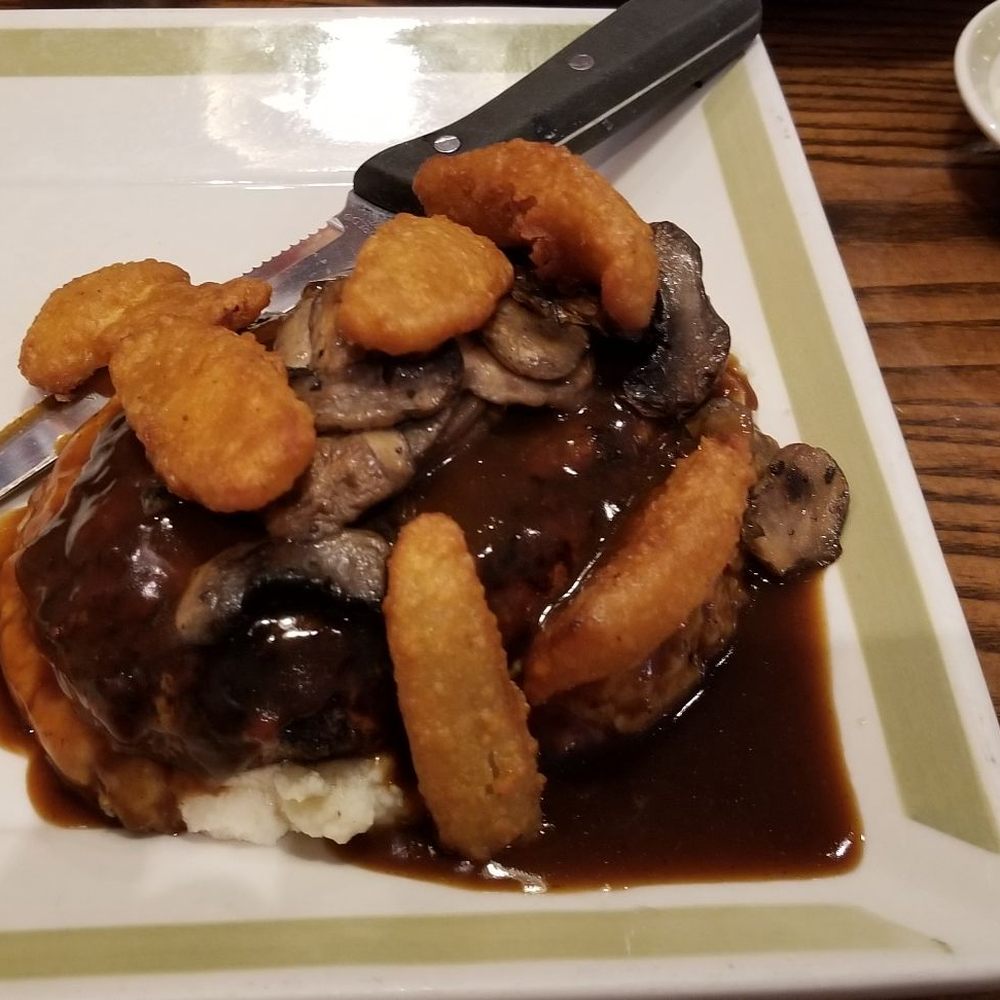 99 Restaurants - Chopped Sirloin over mashed potatoes with onion petals and a red wine gravy!  Very good!! - Pubs Near Me - Kingston, New York