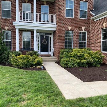 E-Z Lawn - the front of a brick house - Lawn Services Near Me