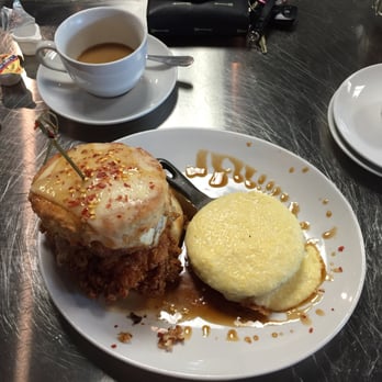 True Flavors Diner - Chicken biscuit with fried green tomato, over easy egg, and chipotle honey glaze. Side of grits. - Diners Near Me - Durham, North Carolina
