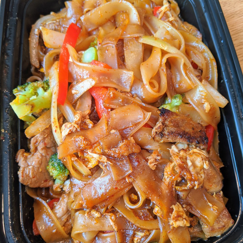 Bangkok 54 - N2. Pad Kee Mow with pork. $12. Pan-fried rice noodles with eggs, broccoli, onions, bell peppers, mushrooms, and basil leaves in brown sauce - Thai Near Me - Chapel Hill, North Carolina