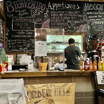 Rojo Marrón - a man standing at a counter - Mexican Near Me - Hinton, Alberta
