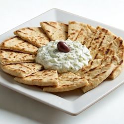 Dinos Kouzina Pizzeria - Our homemade traditional Greek tzatziki sauce served with toasted pita bread.