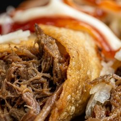 TUCANES Restaurant - Crispy Costa Rican taco tico packed with savory shredded beef, fresh cabbage & sauces. Authentic Latin taste at TUCANES!