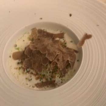 Restaurant Ecco - That is freshly shaven white truffles on top of this egg cheese raviolo. I am salivating just looking at the picture right now - International Near Me - Zürich, ZH