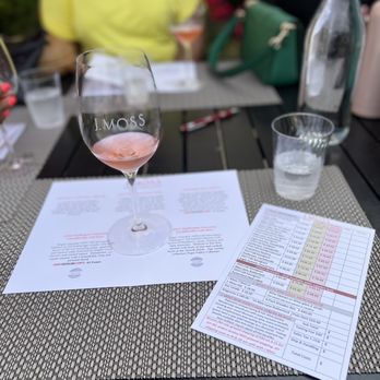 J.Moss - a glass of wine on a table - Wineries Near Me - Napa, California J.Moss - a glass of wine on a table - Wineries Near Me - Napa, California