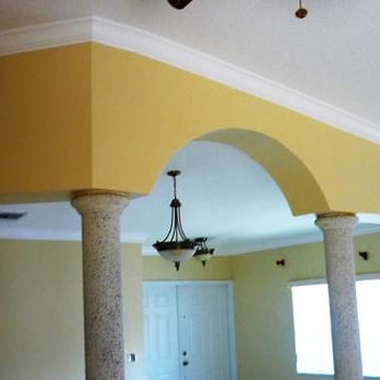 Nieto's Moulding - a room with columns and a chandelier - Flooring Near Me Nieto's Moulding - a room with columns and a chandelier - Flooring Near Me