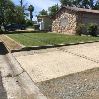 HG LANDSCAPES - a house and a truck parked in front of it - Landscaping Near Me