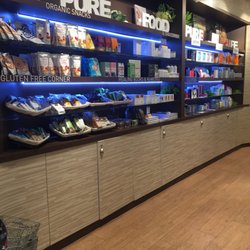 Essenza by Sha - Shelf full of snacks and skincare.