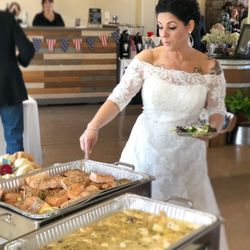 Ambrosia Catering - Bride dishing up our Award Winning Lemon Dill Salmon served with our Signature Dill Sauce