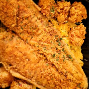 Cuzzo's Cuisine - Fried fish layered over lobster mac n cheese - American Near Me - Charlotte, North Carolina